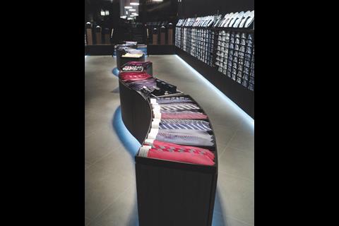 The ambience is distinctly masculine with low lighting, while a gallery of shirts shows off available styles and sizes